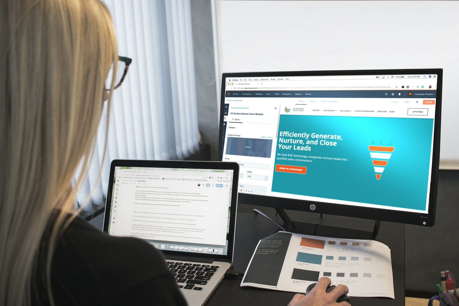 marketing professional reviewing lead data at a computer monitor in a modern office