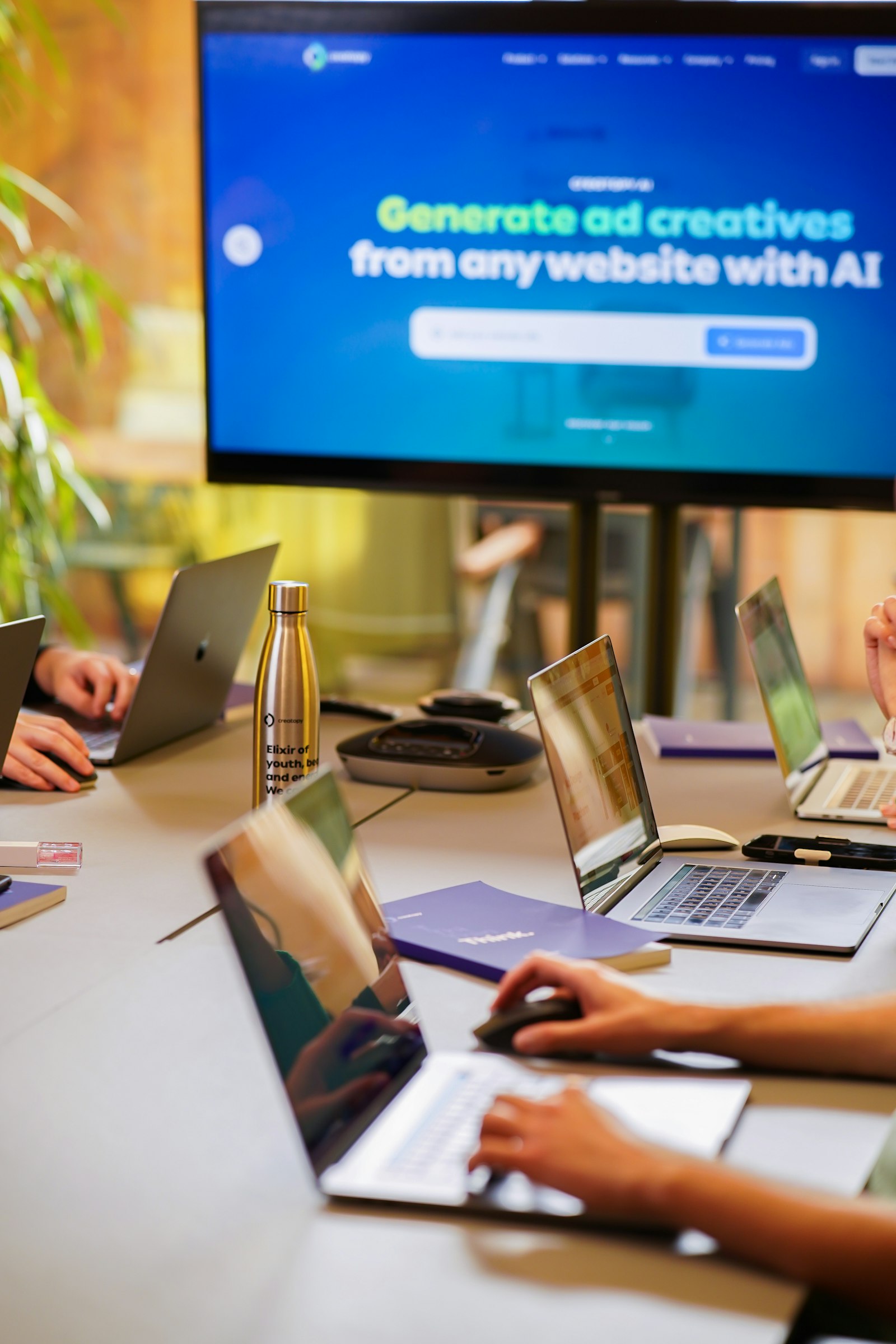 startup marketing team collaborating around laptops during a go-to-market planning session