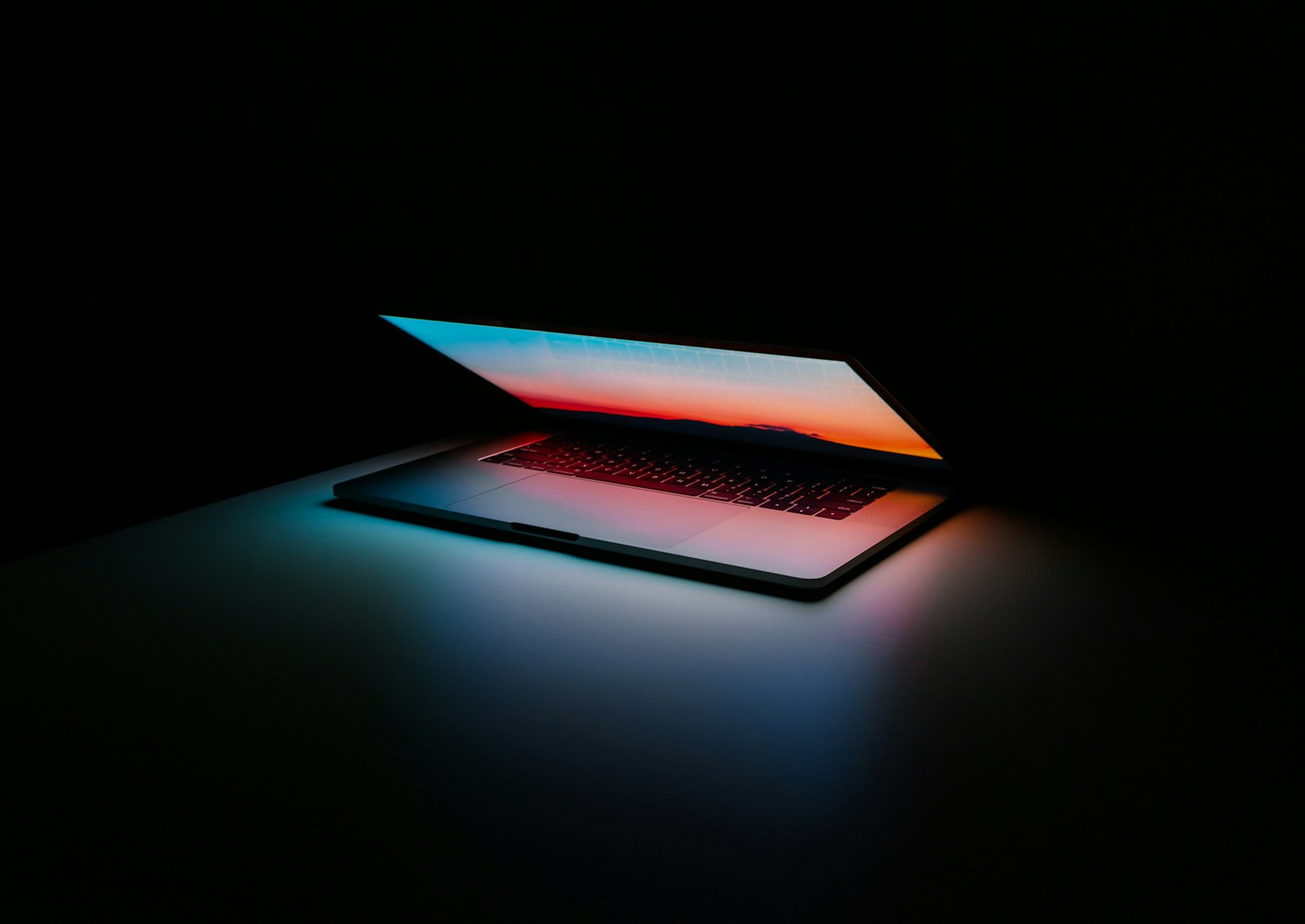 open laptop on a dark desk during tool evaluation