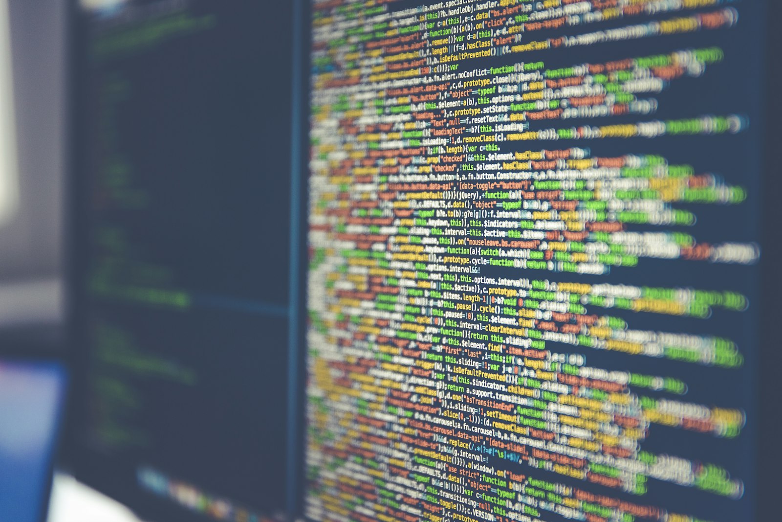 colorful code on multiple monitors showing the programmatic backbone of AI marketing automation
