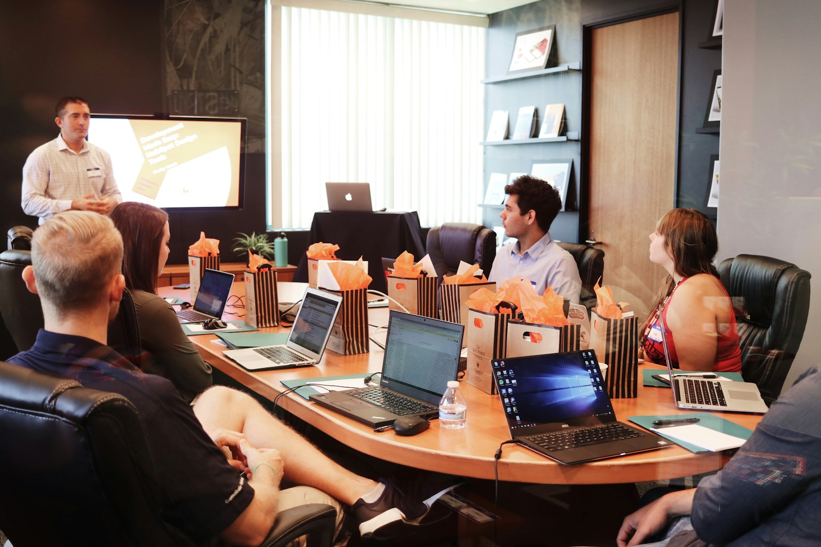 marketing professional reviewing AI-prepared work on laptop before approving
