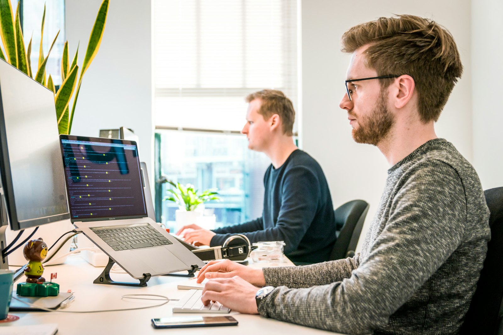 marketer analyzing full-funnel performance metrics on laptop in office